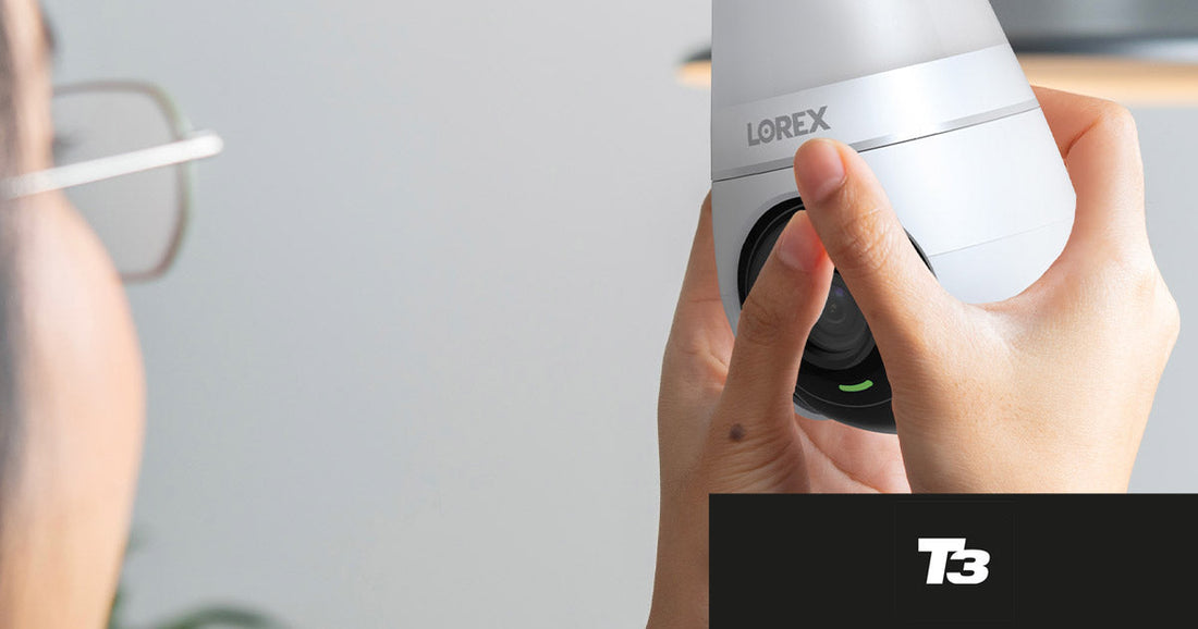 A person holding the Lorex Smart Lightbulb Camera during installation, featured in T3’s roundup of favorite affordable, subscription-free smart home security deals.