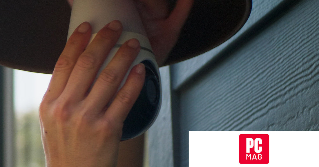 Close-up of a person installing the Lorex Smart Lightbulb Camera into an outdoor light socket, featured in PCMag’s smart home holiday gift guide.
