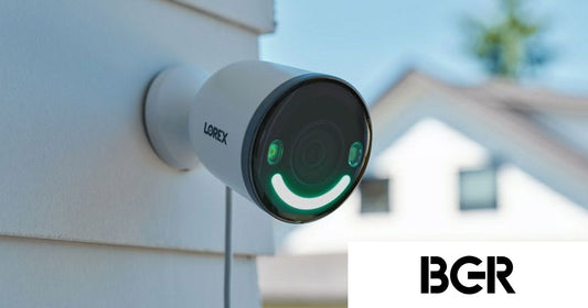 Lorex 4K Spotlight Wi-Fi 6 security camera mounted on an exterior wall of a home, with green smart security lighting illuminated, featured in BGR’s coverage of the best security cameras with local storage.