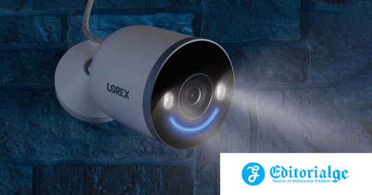 Lorex 4K Spotlight Wi-Fi Security Camera mounted outdoors on a brick wall at night, with LED lights illuminated and Smart Security Lighting glowing blue, featured in Editorialge’s best no-fee security cameras roundup.