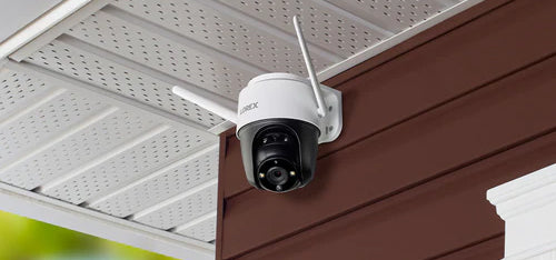 Lorex 2K outdoor pan-tilt Wi-Fi camera mounted under eaves for Prime Day deal.
