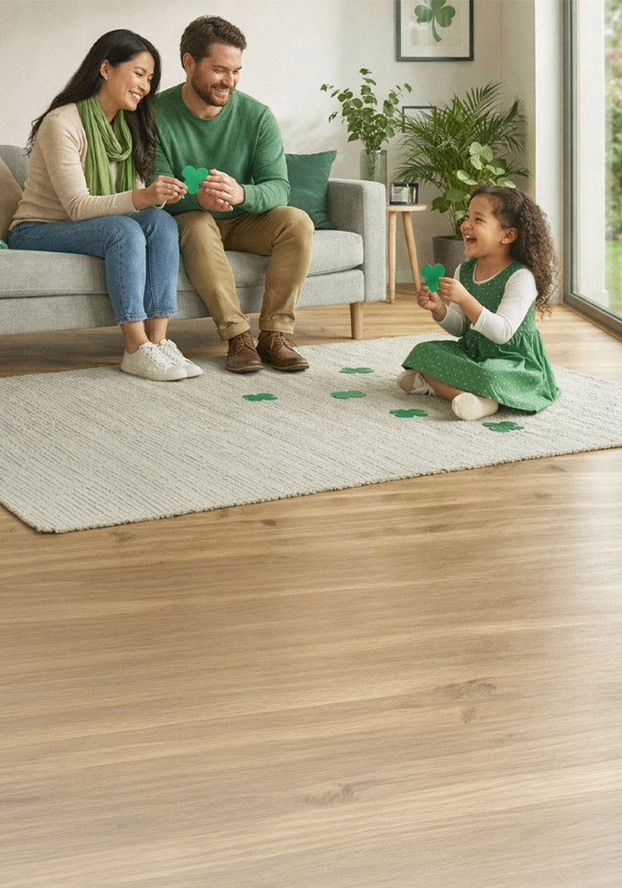 Family sitting in a living room with a child playing with shamrock shapes while a Lorex security camera is mounted near a large window