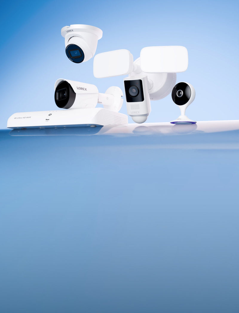 Group of Lorex security devices on a blue gradient backdrop, including a 4K NVR, outdoor IP camera, a floodlight security camera, and a compact indoor Wi-Fi camera.