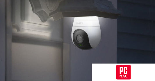 Lorex 2K Smart Wi-Fi Lightbulb Camera installed in a porch light fixture at night, featured in PCMag’s 2026 outdoor security camera roundup.