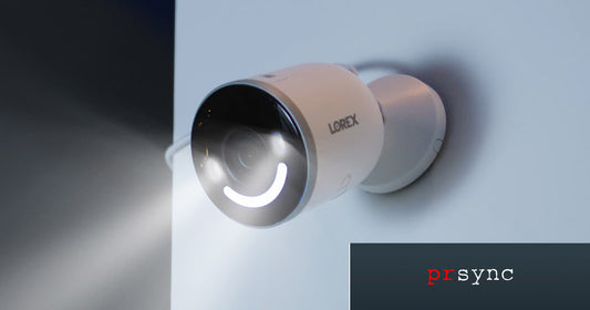 Lorex 4K Spotlight Wi-Fi 6 Security Camera mounted on a white brick wall, with its smart security light activated—featured in a report on Europe’s growing home security market.
